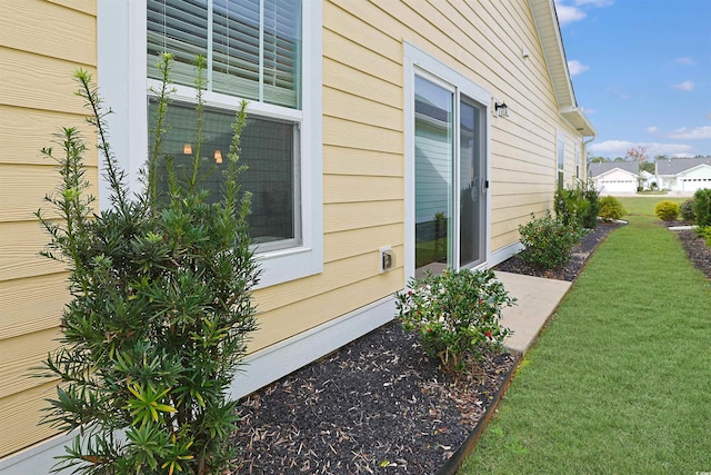 view of side of property with a yard