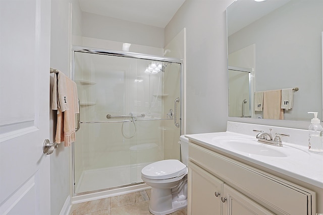 bathroom featuring tile patterned floors, a shower with shower door, and toilet