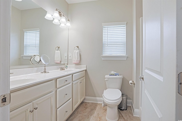 bathroom with tile patterned flooring, vanity, and toilet