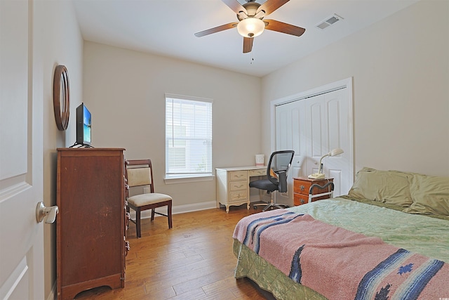 bedroom featuring ceiling fan, a closet, and light hardwood / wood-style flooring