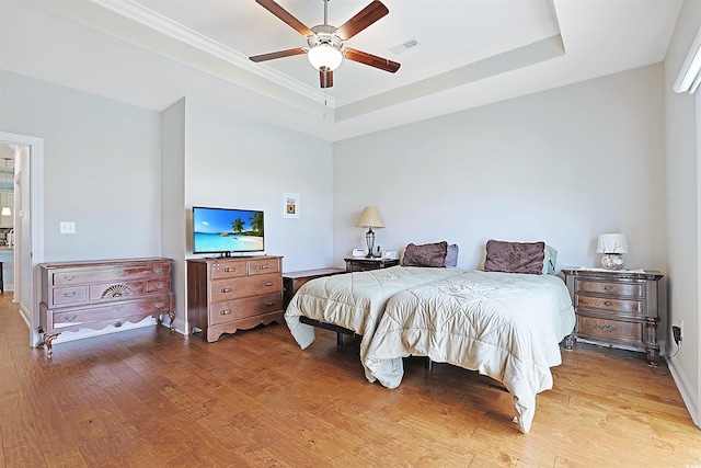 bedroom with ceiling fan, light hardwood / wood-style floors, and ornamental molding