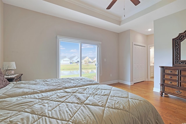 bedroom with access to outside, crown molding, ceiling fan, light hardwood / wood-style floors, and a closet