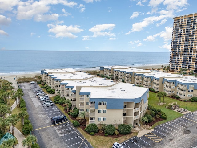 aerial view with a water view and a view of the beach