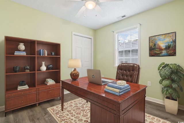 office featuring a textured ceiling, dark hardwood / wood-style floors, and ceiling fan