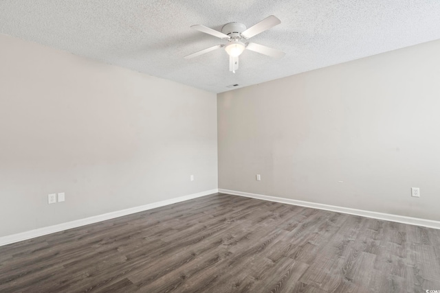 unfurnished room with ceiling fan, dark hardwood / wood-style flooring, and a textured ceiling