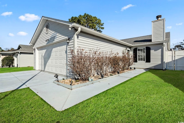 view of side of home featuring a garage and a yard