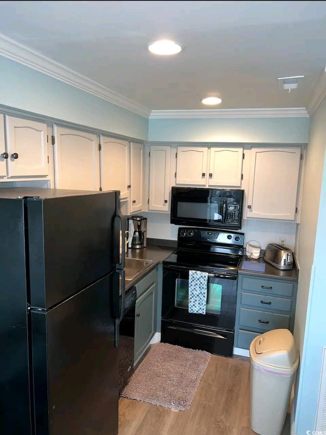 kitchen featuring black appliances, white cabinetry, ornamental molding, and light hardwood / wood-style flooring