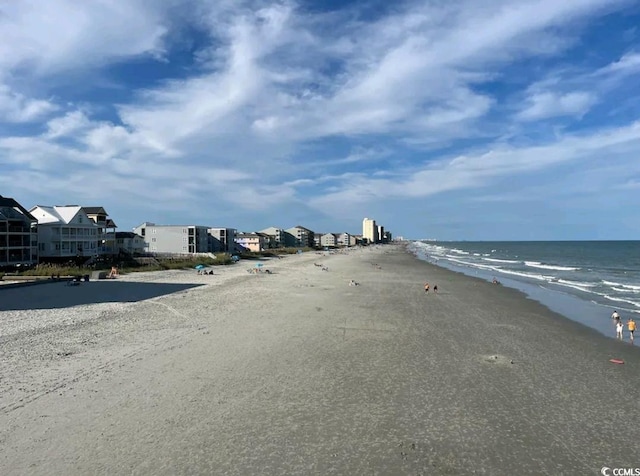 view of street featuring a beach view and a water view