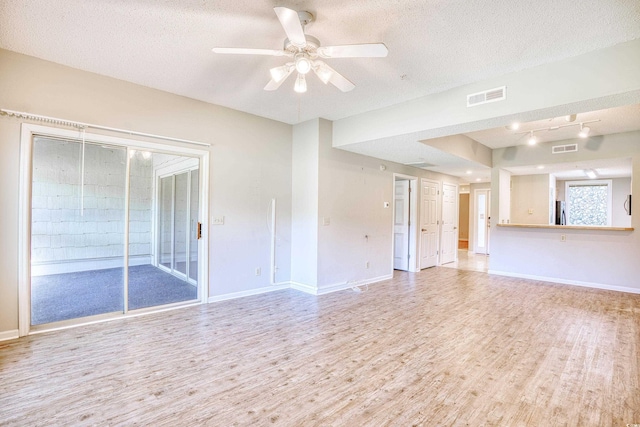 unfurnished living room with ceiling fan, a textured ceiling, and light wood-type flooring