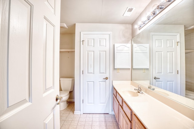 bathroom featuring tile patterned floors, vanity, and toilet