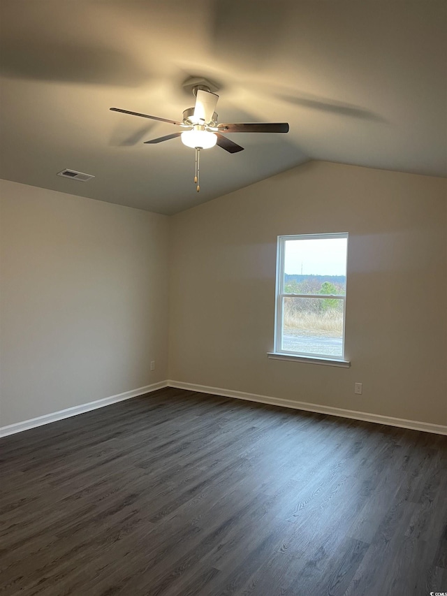spare room featuring ceiling fan, dark hardwood / wood-style flooring, and vaulted ceiling