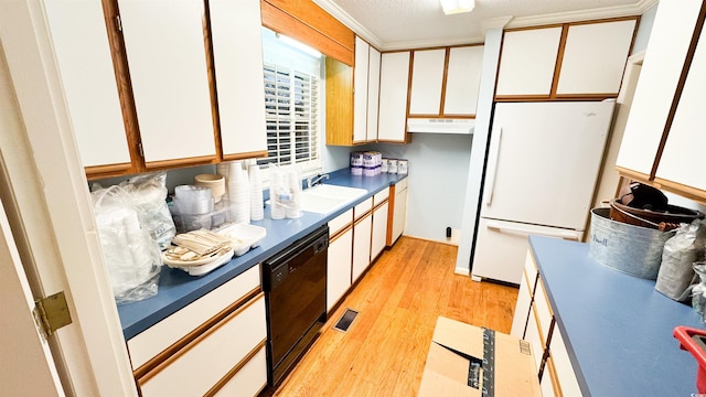 kitchen with dishwasher, sink, white cabinets, white refrigerator, and light hardwood / wood-style floors