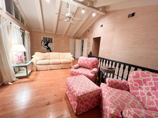 living room with beamed ceiling, ceiling fan, high vaulted ceiling, and hardwood / wood-style flooring