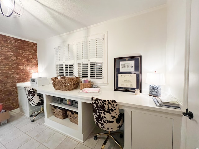 office featuring crown molding, built in desk, a textured ceiling, light tile patterned floors, and brick wall