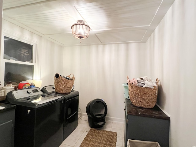 laundry room with light tile patterned floors and washer and clothes dryer