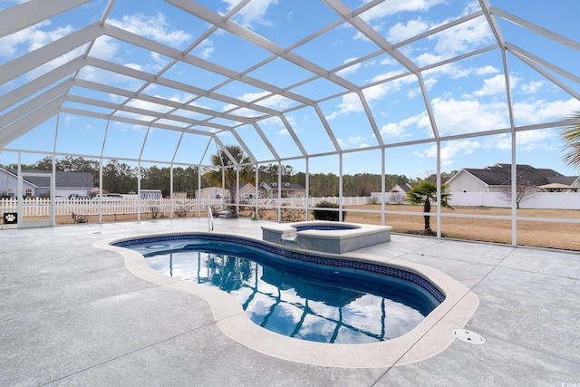 view of swimming pool featuring glass enclosure, an in ground hot tub, and a patio