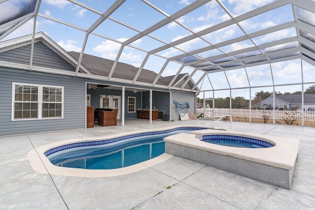 view of pool with an in ground hot tub, a patio, ceiling fan, and a lanai