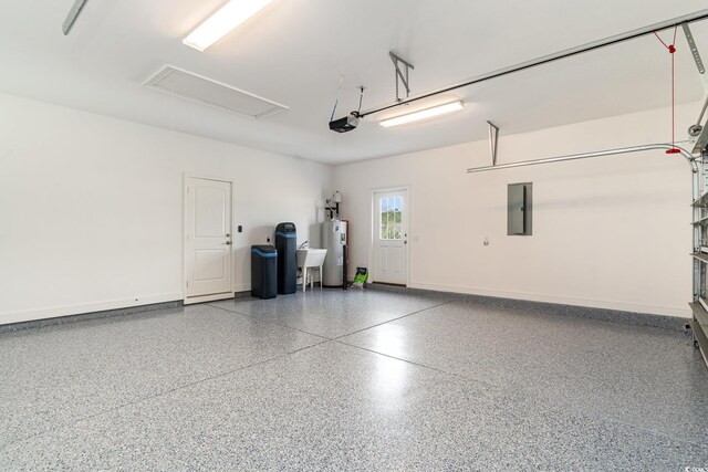 garage with electric panel, electric water heater, and a garage door opener