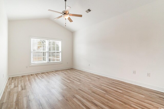 empty room featuring vaulted ceiling, light hardwood / wood-style flooring, and ceiling fan