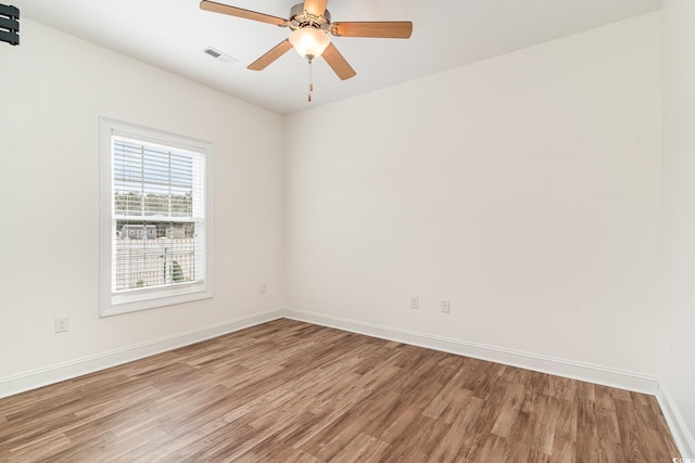 empty room featuring hardwood / wood-style flooring and ceiling fan