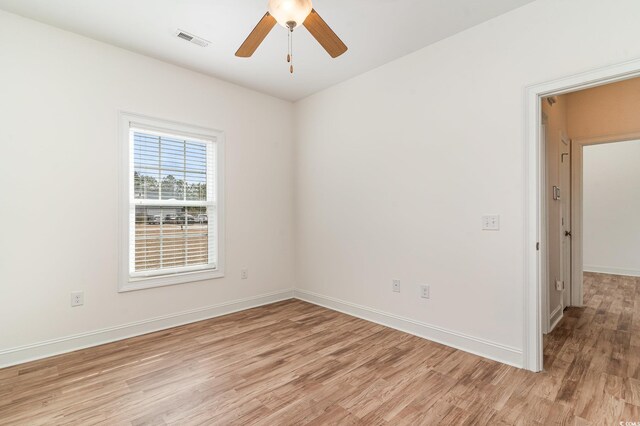 spare room with ceiling fan and light wood-type flooring