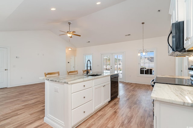 kitchen with a center island with sink, black appliances, white cabinets, sink, and hanging light fixtures