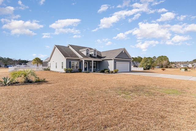 view of front of home with a garage and a front lawn