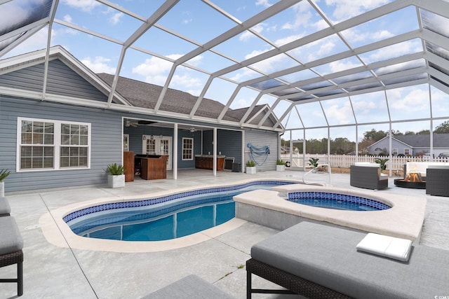 view of swimming pool featuring a lanai, a patio area, and ceiling fan