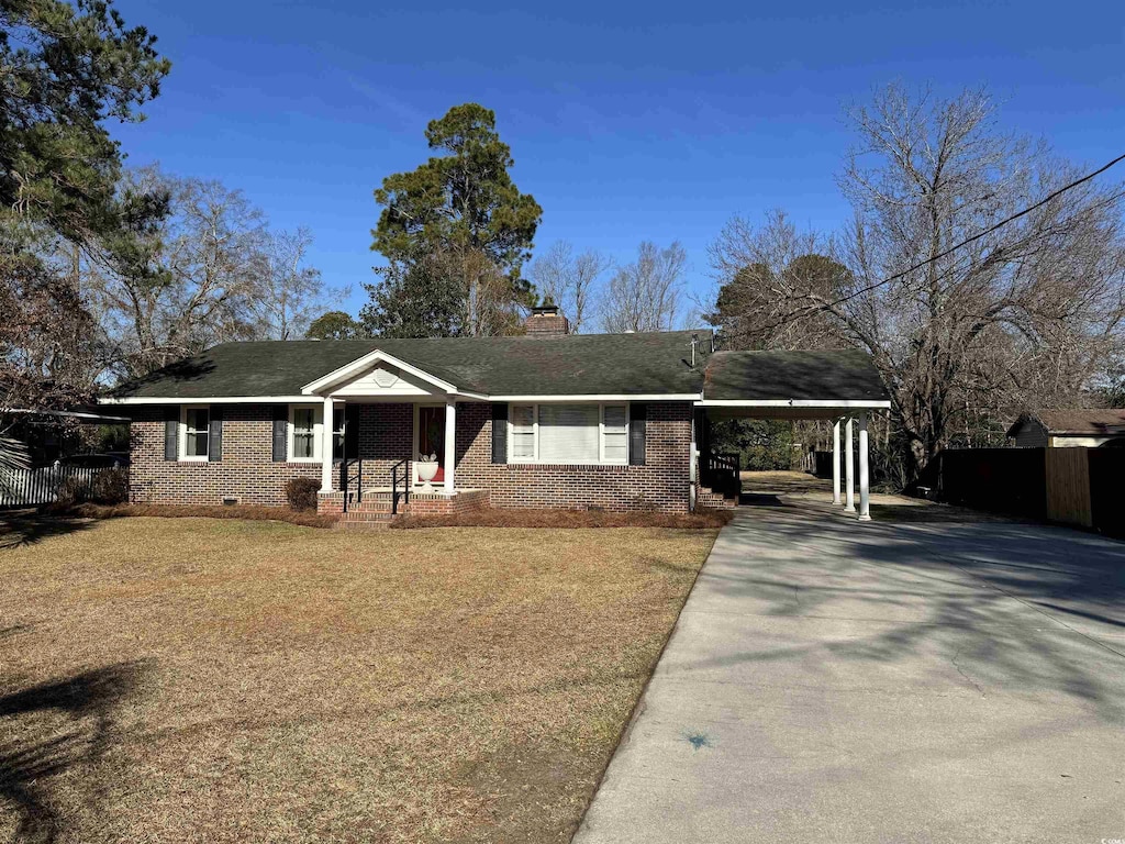 ranch-style house with a carport and a front lawn