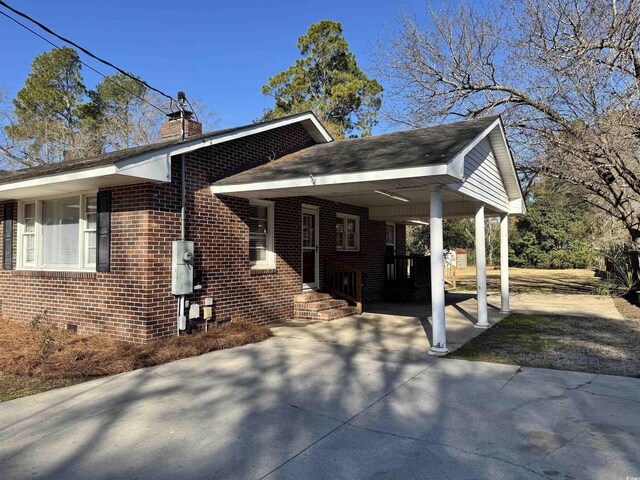 view of side of home featuring a carport