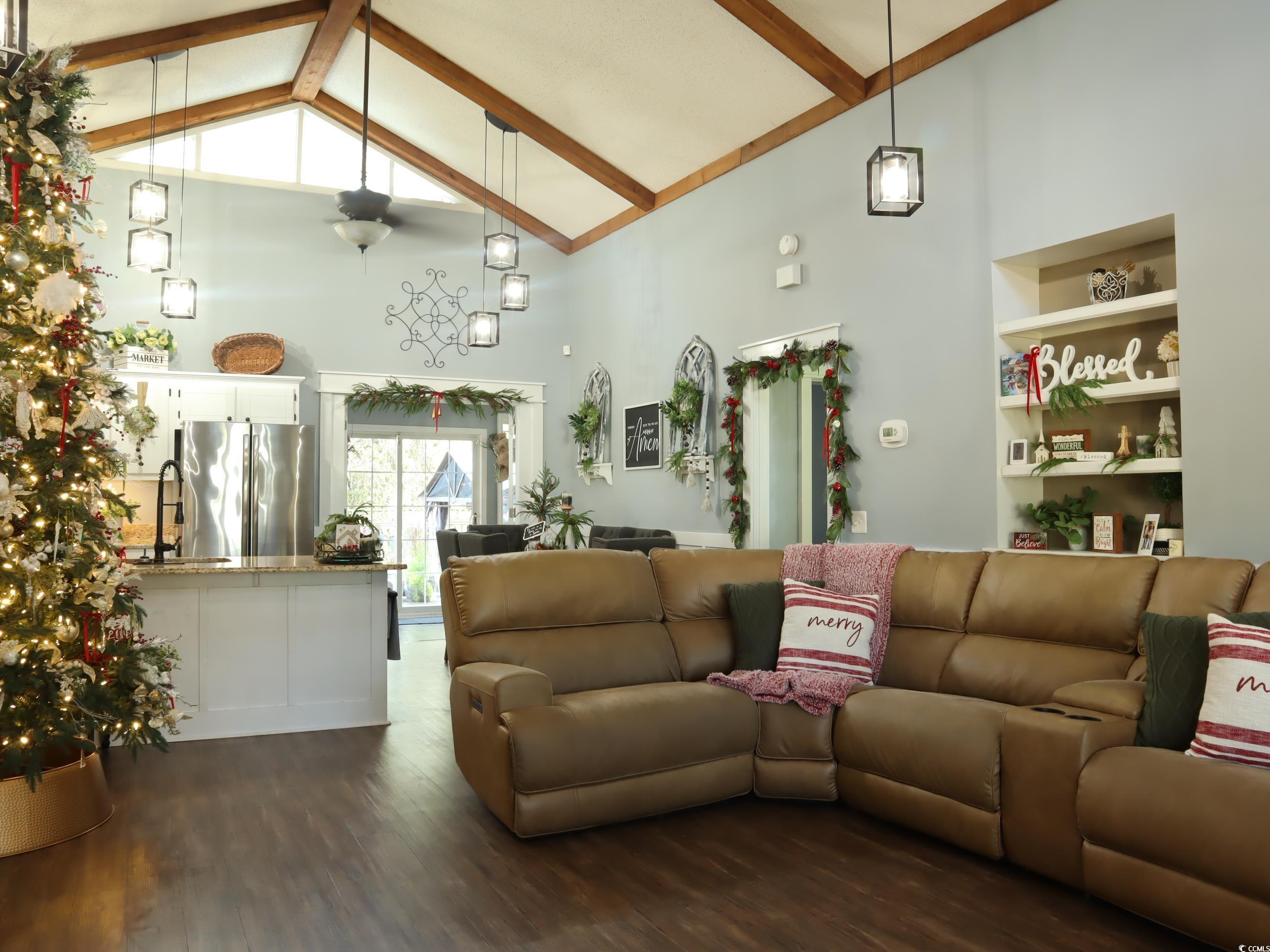 living room featuring high vaulted ceiling, sink, ceiling fan, beamed ceiling, and dark hardwood / wood-style flooring