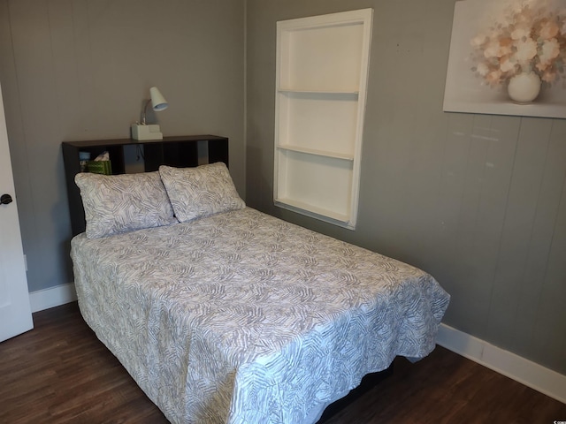 bedroom with dark hardwood / wood-style floors