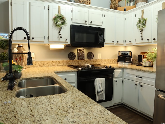 kitchen featuring white cabinetry, sink, dark wood-type flooring, light stone counters, and black appliances