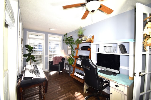 home office with a textured ceiling and dark hardwood / wood-style floors