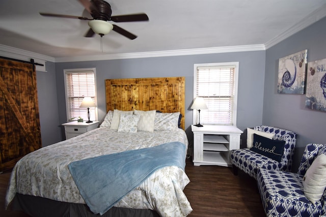 bedroom with a barn door, ceiling fan, crown molding, and dark hardwood / wood-style floors