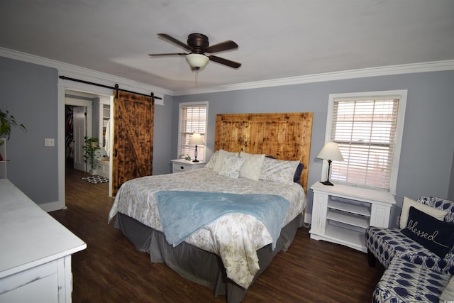 bedroom with a barn door, crown molding, ceiling fan, and dark wood-type flooring