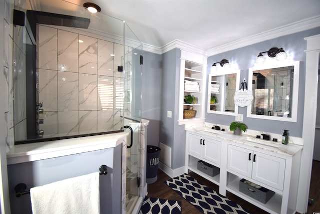 bathroom featuring vanity, a shower with door, wood-type flooring, and crown molding