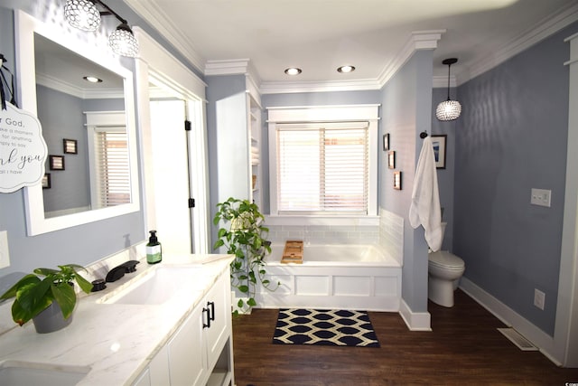 bathroom with a tub, wood-type flooring, toilet, vanity, and ornamental molding