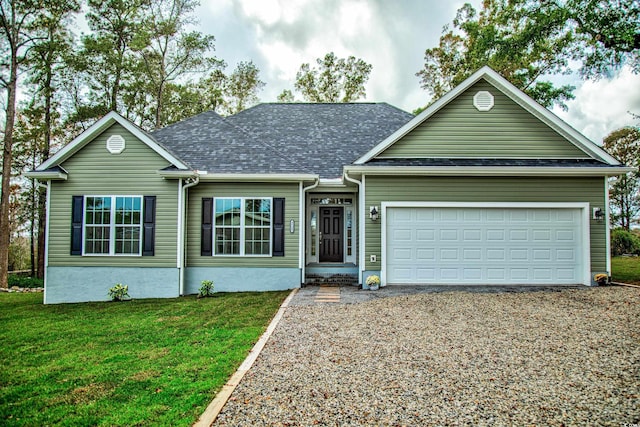 ranch-style home featuring a front lawn and a garage