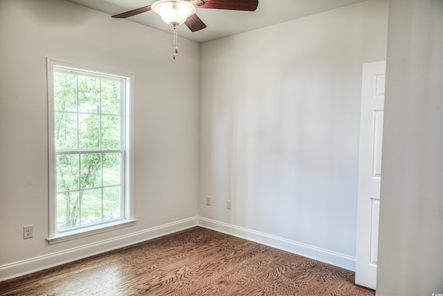 empty room with dark hardwood / wood-style floors and ceiling fan