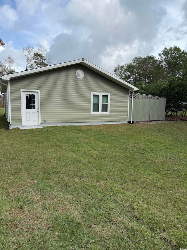 back of house with a lawn