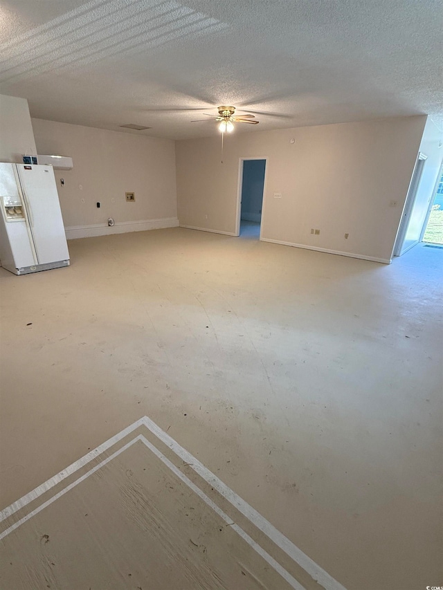 spare room with ceiling fan and a textured ceiling