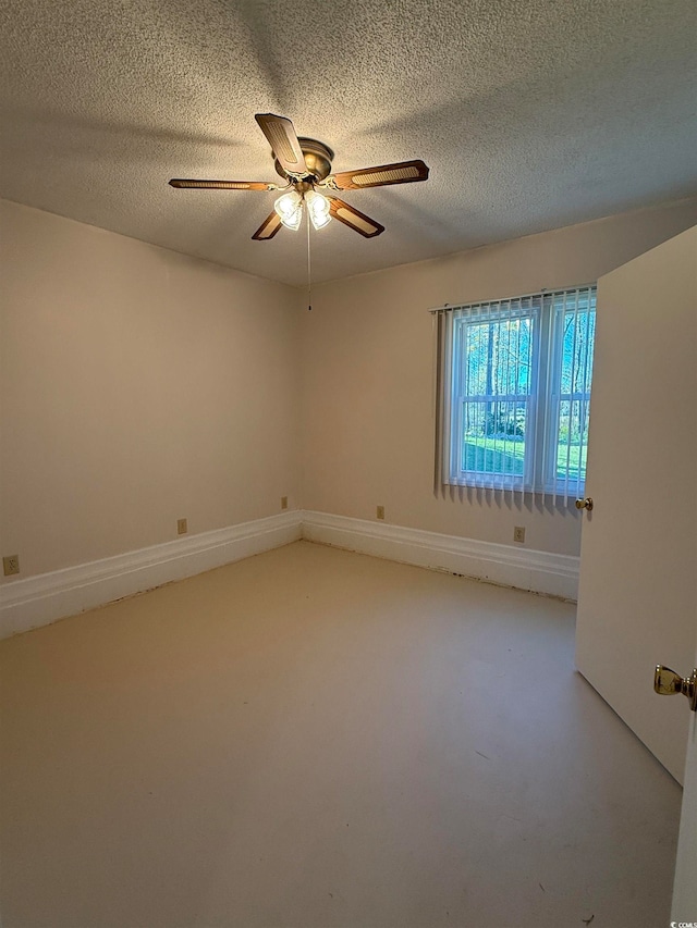 spare room with ceiling fan and a textured ceiling