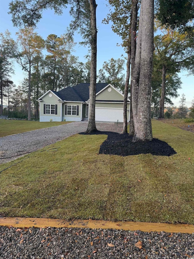 view of front of home featuring a garage and a front lawn