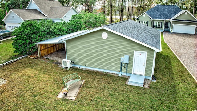 view of outdoor structure with a yard and ac unit