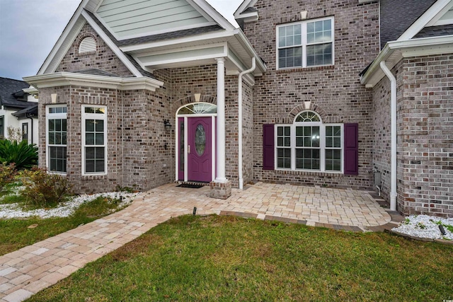 property entrance featuring a yard and a patio area