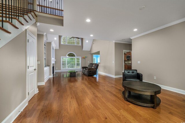 entrance foyer featuring crown molding and light hardwood / wood-style flooring