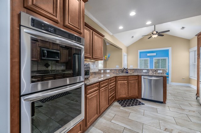 kitchen featuring backsplash, dark stone countertops, sink, and stainless steel appliances