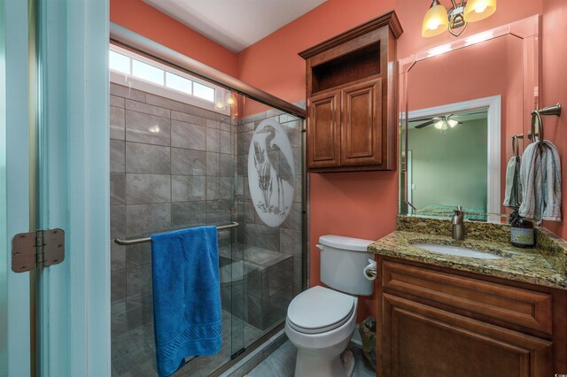 bedroom featuring dark hardwood / wood-style floors, ensuite bath, and ceiling fan