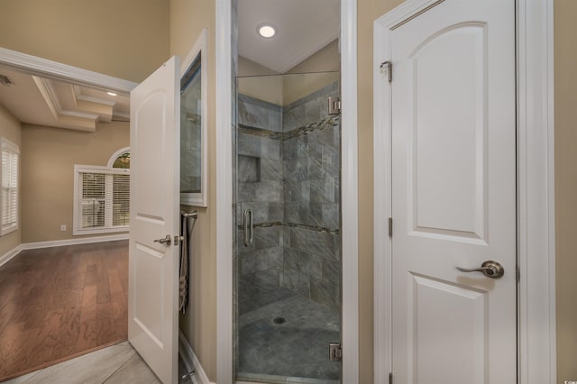 bathroom featuring walk in shower, wood-type flooring, and crown molding